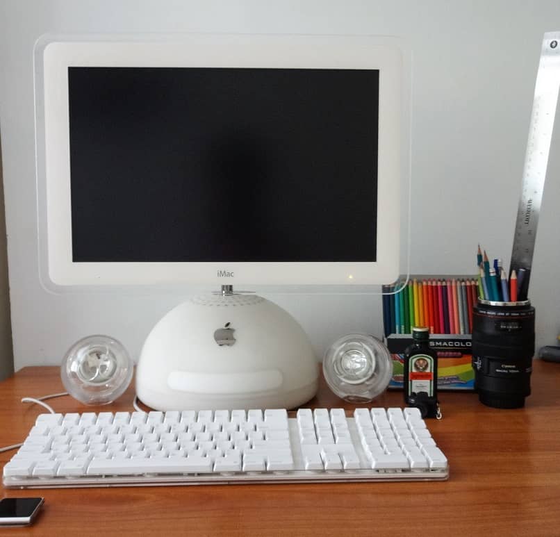 apple imac on desktop with some colors