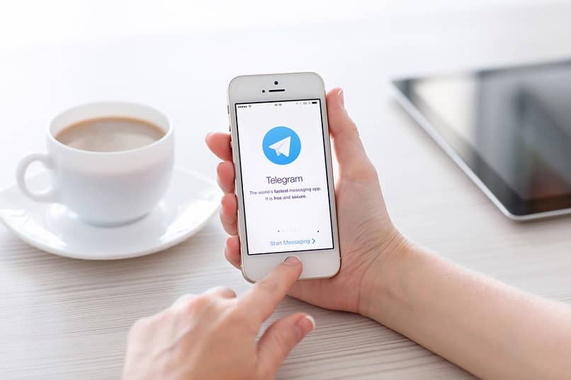 person using telegram while drinking coffee