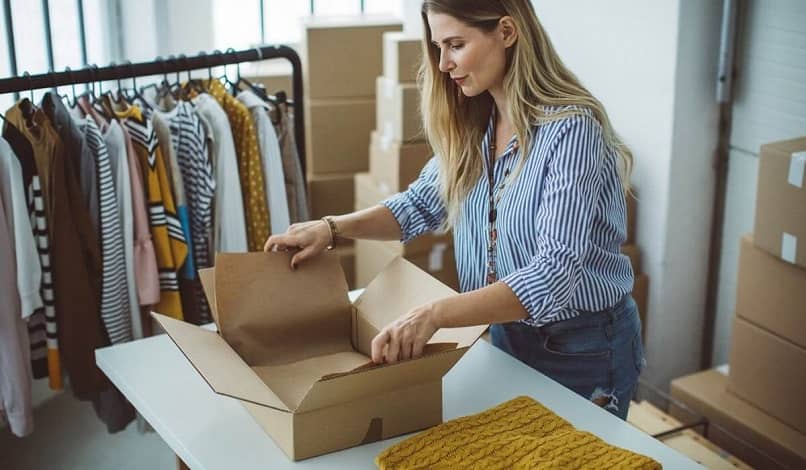 woman packing clothes to sell