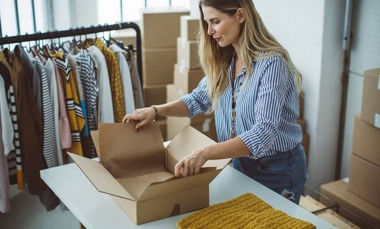 woman packing clothes to sell