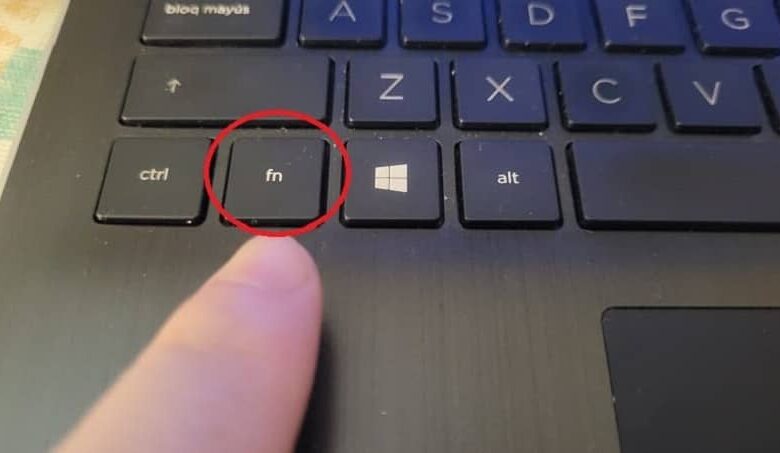 finger pointing to the fn key