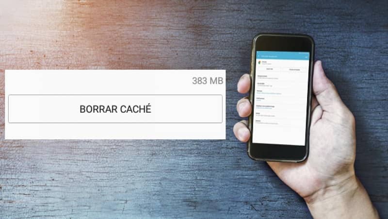 Hand holding a mobile with delete cache button 
